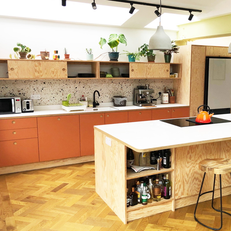 Stunning bespoke kitchen with european pine plywood and terracotta laminate on a heringbone wooden floor