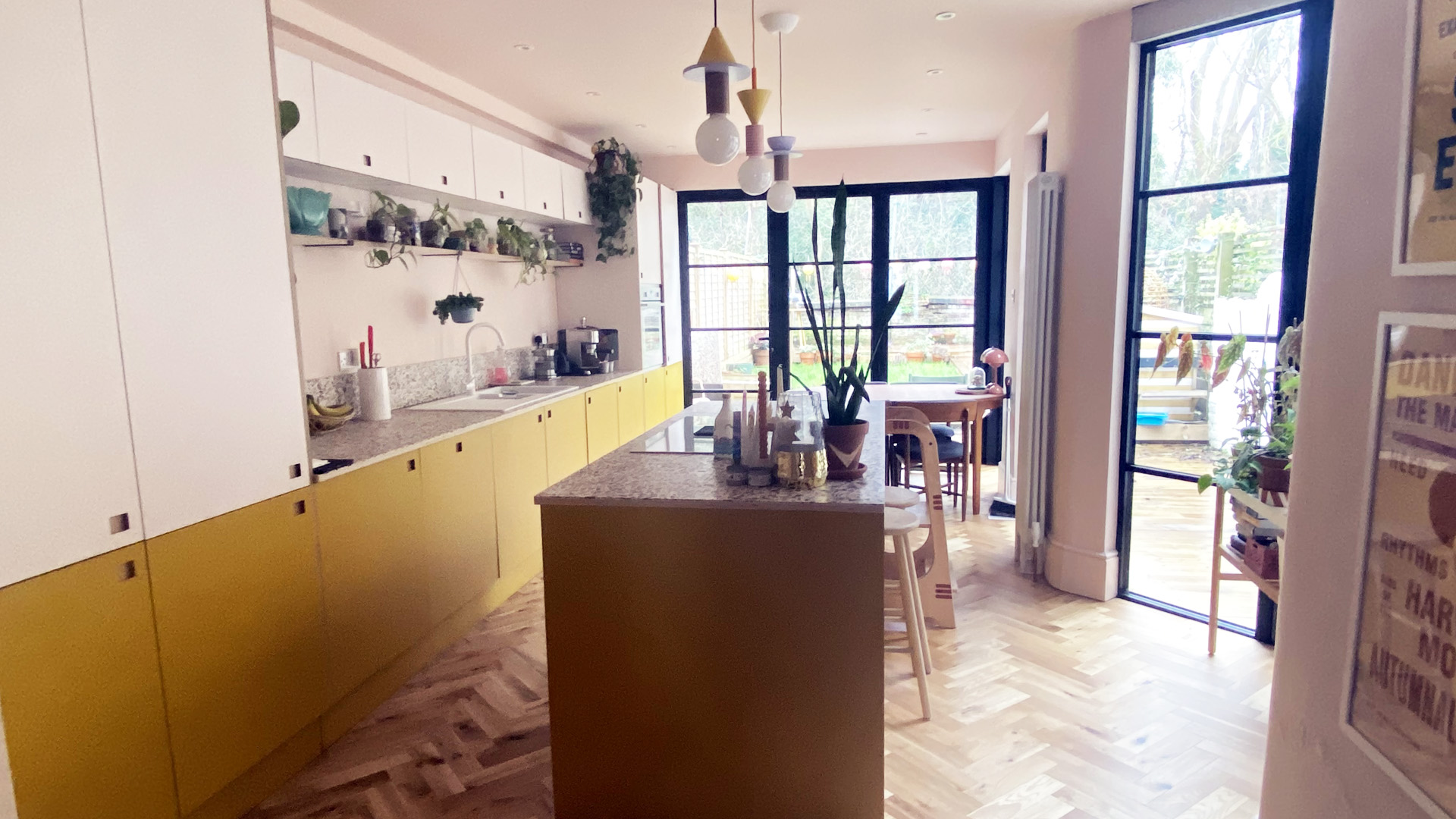 contemporary kitchen with pink laminate top doors and yellow laminate base units