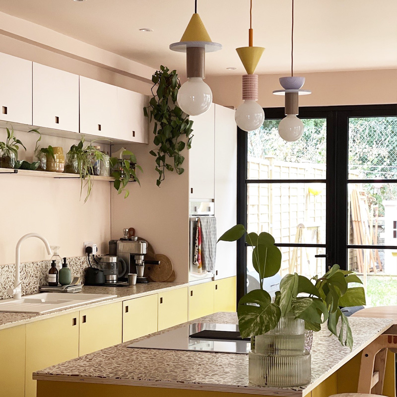 Kitchen rennovation with plywood doors in pink and yellow laminate with square finger hole handles