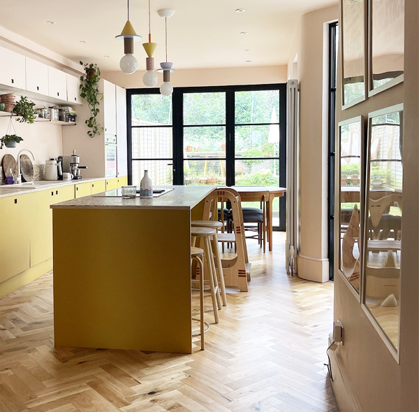 looking through kitchen from hall showing yellow laminate and plywood finishes